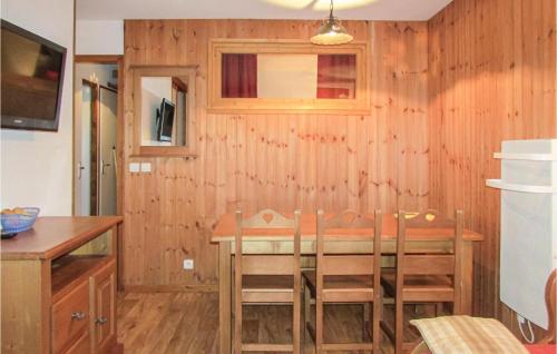 une cuisine avec une table et des chaises dans une pièce dans l'établissement Gorgeous Apartment In Puy St Vincent, à Narreyroux