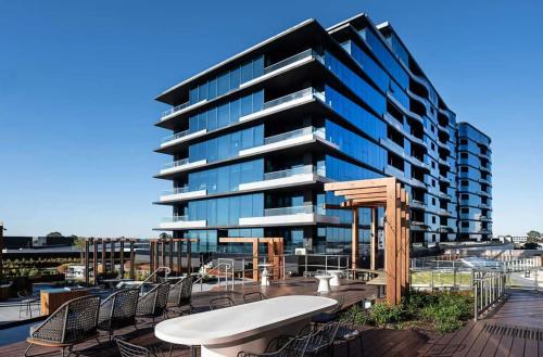 a building with a table and chairs in front of it at Heart of Glen Waverley Pool Gym Parking in Glen Waverley