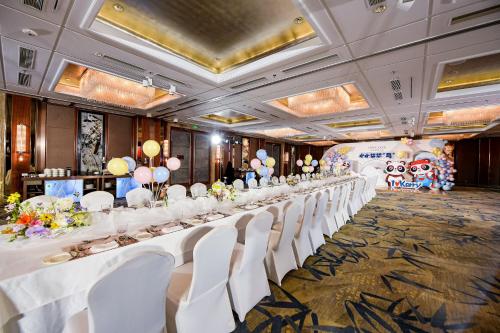 a long table with white chairs in a room at Kerry Hotel, Beijing by Shangri-La - 5 Kilometers to The Forbidden City in Beijing