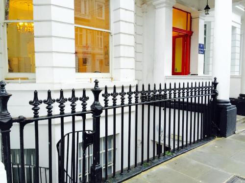 a black fence in front of a building at Acacia Hotel in London