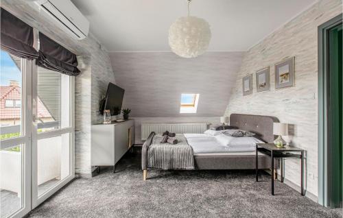 a bedroom with a bed and a tv in it at 3 Bedroom Gorgeous Home In Podamirowo in Podamirowo