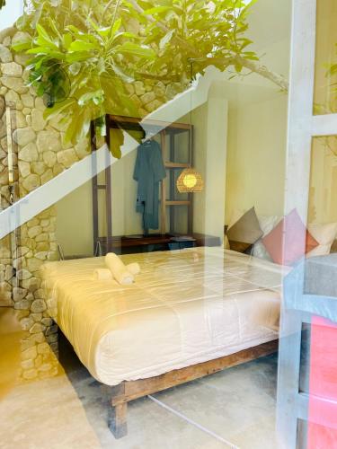 a bedroom with a bed with a tree in it at New Yêu Biển homestay in Vĩnh Hy