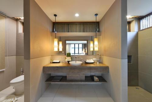 a bathroom with a sink and a toilet at Twin Lotus Resort and Spa - SHA Plus - Adult Only "November - April" in Ko Lanta