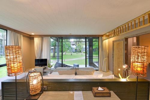 a living room with a couch and a large window at Twin Lotus Resort and Spa - SHA Plus - Adult Only "November - April" in Ko Lanta