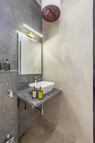 a bathroom with a sink and a mirror at ELIVAAS 5 BHK With Pvt Pool & Garden - Zenora in Gurgaon