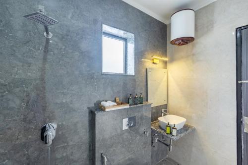 a bathroom with a shower and a sink at ELIVAAS 5 BHK With Pvt Pool & Garden - Zenora in Gurgaon