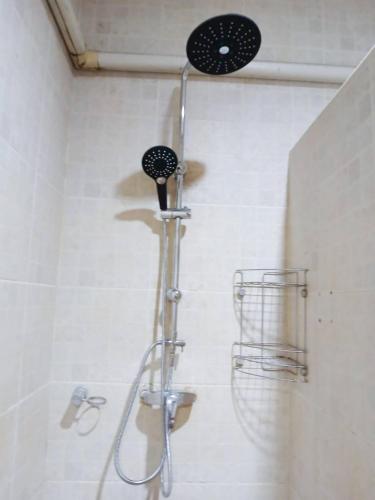 a shower with a shower head in a bathroom at Samui Wooden Hill Resort in Lamai