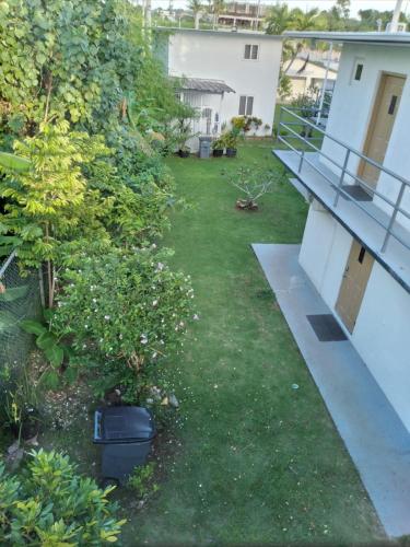 a yard with a bench and a plant at Ocean Villa Guam in Tamuning