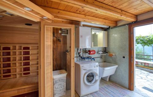 a bathroom with a washing machine and a sink at Alla Cocca in San Donato