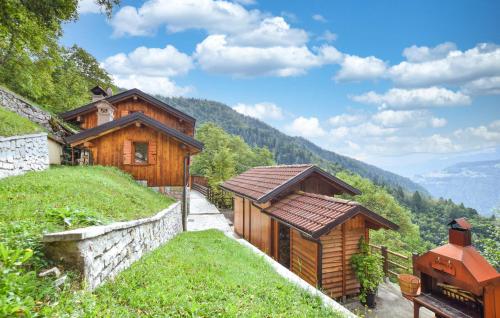 a wooden house on a hill with mountains in the background at Alla Cocca in San Donato
