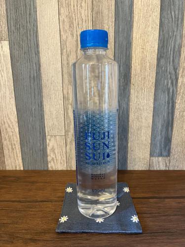 a bottle of water sitting on a napkin at Cycle Guest House SHIOKAZE in Setoda