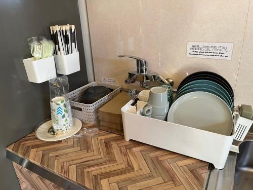 a kitchen counter with a sink and a sink at Cycle Guest House SHIOKAZE in Setoda