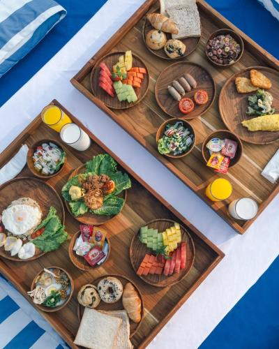 a tray of food on a table with plates of food at Novus Jiva Anyer in Anyer