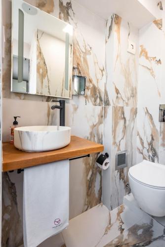 a bathroom with a sink and a toilet at Aurora Hills Hotel in Plovdiv