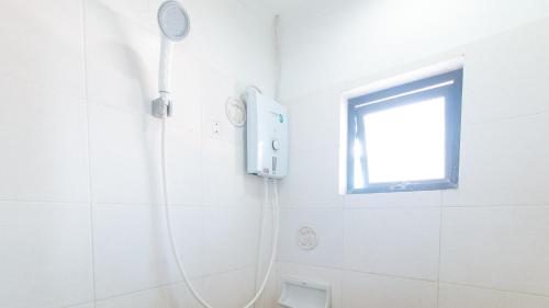 a shower in a white bathroom with a window at RedDoorz Plus New Era Budget Hotel Mabolo former RedDoorz near Landers Superstore Cebu City in Cebu City