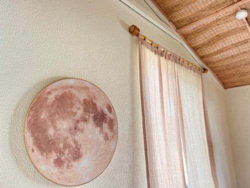 a moon picture on a wall next to a window at New Yêu Biển homestay in Vĩnh Hy
