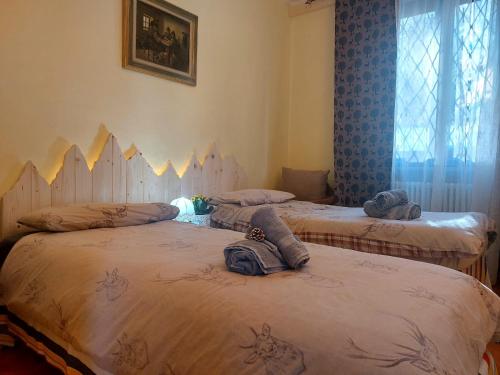 a room with three beds with towels on them at APPARTAMENTO CHEMIN DE FER in Saint Vincent