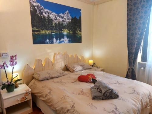 a bedroom with a bed with a stuffed animal on it at APPARTAMENTO CHEMIN DE FER in Saint Vincent