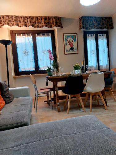 a living room with a table and chairs at APPARTAMENTO CHEMIN DE FER in Saint Vincent