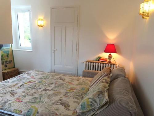 a bedroom with a bed and a lamp and a window at Studio lumineux à 100m de la plage ! in Saint-Jean-de-Luz