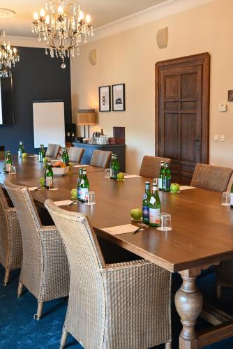 a conference room with a wooden table and chairs at Chateau d'Urspelt in Urspelt