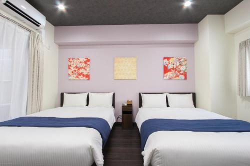 Katil atau katil-katil dalam bilik di Parkside Inn Hakata