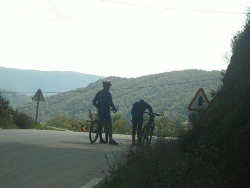 two people standing next to their bikes on the side of a road at Casa da Fonte de Travanca in Travanca