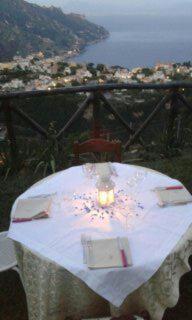 a table with a white table cloth and a candle at B&B Oliva in Scala