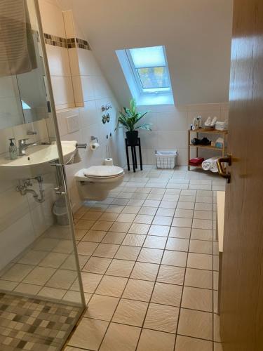 a bathroom with a toilet and a sink at Lovely Central Located- Train, Restaurants & Spa in Kassel