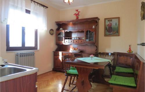 a kitchen with a table and chairs and a sink at Mariza in Rošini