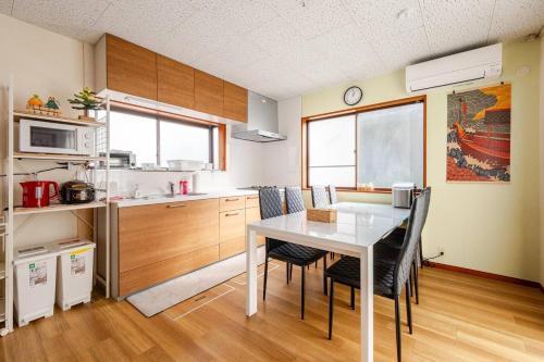 a kitchen with a table and chairs in a room at Vacation Stay Fuji - 桜館 in Fujikawaguchiko