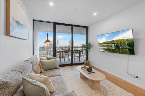 a living room with a couch and a table at The Haven - Brand New Riverview 2BR with Parking Pool GYM at Surfers Paradise in Gold Coast