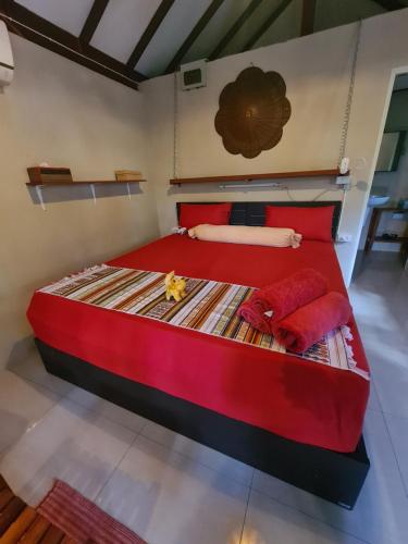 a large red bed with red pillows in a room at Red Moon Hideaway in Ko Chang