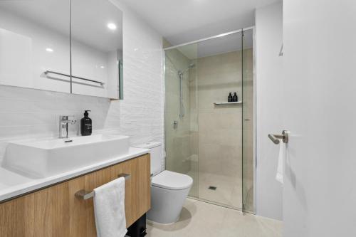 a bathroom with a sink and a toilet and a shower at The Haven - Brand New Riverview 2BR with Parking Pool GYM at Surfers Paradise in Gold Coast