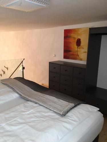 a bedroom with a bed and a painting on the wall at Deluxe Apartment Sonnleitner - ADULTS ONLY in Furth