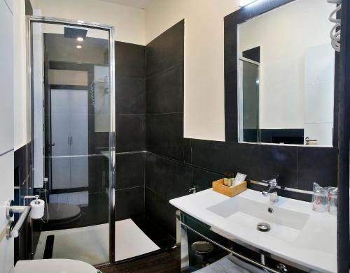 a bathroom with a sink and a shower at Alhambra Suites in Madrid
