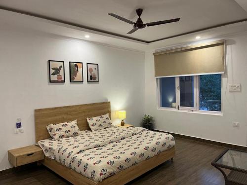 a bedroom with a bed and a ceiling fan at Himtrek Stays,Mcleodganj in McLeod Ganj