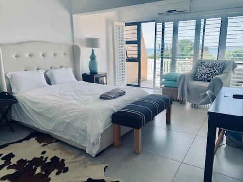 Un dormitorio con una cama, un escritorio y una silla. en Hawaan View, en Durban
