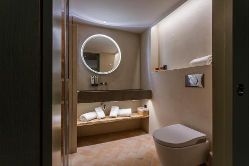 a bathroom with a toilet and a mirror at Hostal Olga in Sant Antoni de Calonge