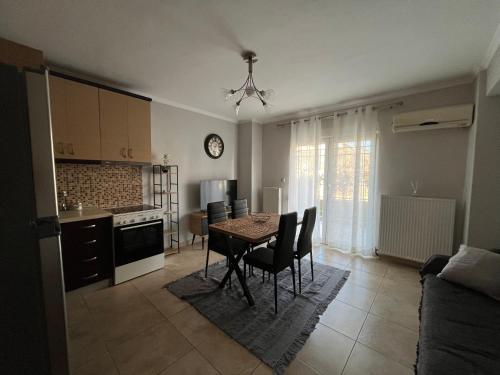 a kitchen and dining room with a table and chairs at Peaceful Nook in Alexandroupoli