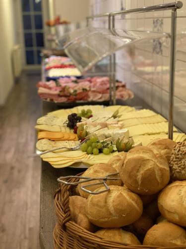 a buffet of food with bread and other foods at Pension Frisia in Norddeich