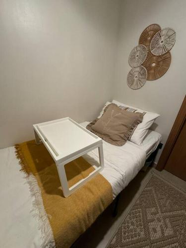a white table sitting on top of a bed at Small details1 Self-check-in in Riyadh