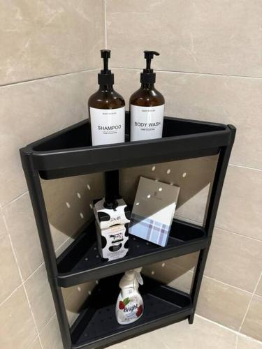 a shelf in a bathroom with two bottles on it at Small details1 Self-check-in in Riyadh