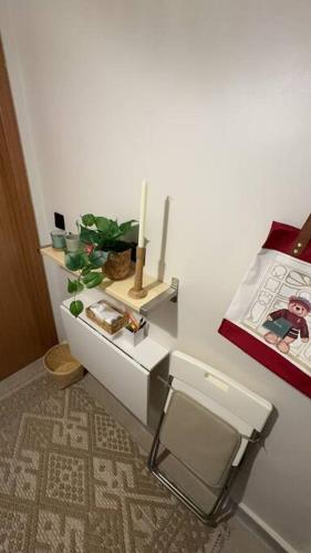 a bathroom with a toilet and a table with a plant at Small details1 Self-check-in in Riyadh