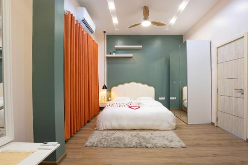 a bedroom with a white bed and green walls at Blue Sky Beach in Hulhumale