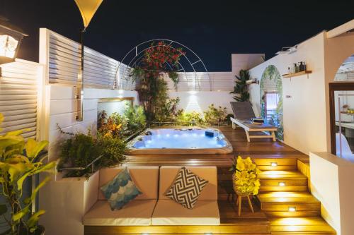 a hot tub in the middle of a patio at Blue Sky Beach in Hulhumale