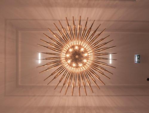 a chandelier hanging from a ceiling in a room at Royale Sainte Hélène Boutique Hotel in Birkirkara