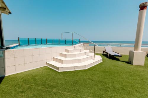 a set of stairs next to a swimming pool with avisorvisor at Beach Hotel Swakopmund in Swakopmund
