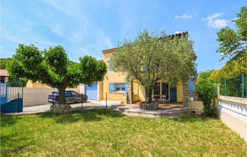 a house with a tree in a yard at Lovely Home In Saint-Maurice-Sur-Eygu in Saint-Maurice-sur-Eygues