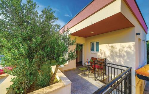 a balcony of a house with a tree at Amazing Home In Kastel Stafilic in Plano